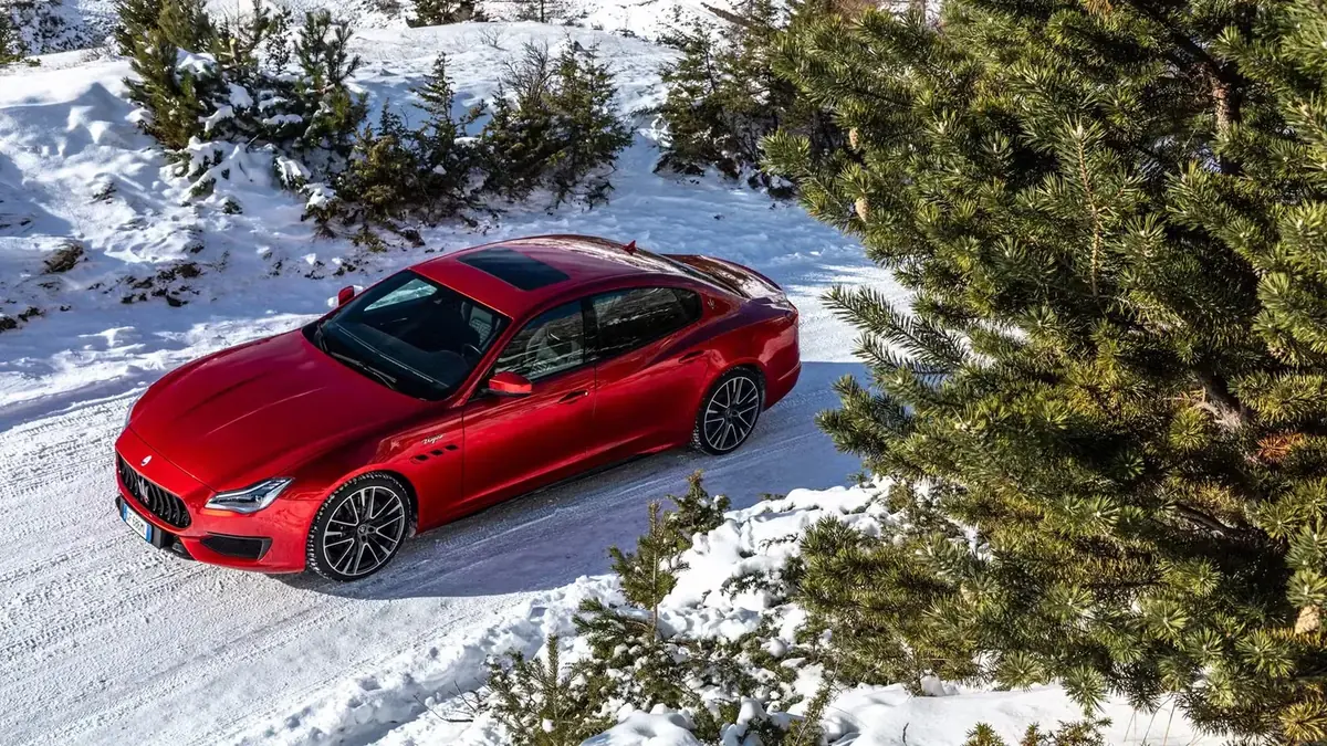 Red sixth-generation Maserati Quattroporte viewed from above on a snow-covered road